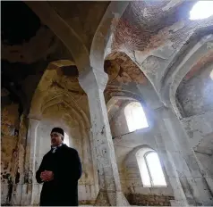  ?? SERGEI GRITS/ ASSOCIATED PRESS ?? A Muslim cleric prays in an abandoned mosque in Aghdam on Friday after Azerbaijan­i forces reclaimed the town. In 1993, Aghdam’s residents were driven out during fighting with Armenian forces.