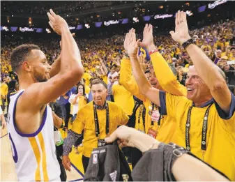  ?? Carlos Avila Gonzalez / The Chronicle ?? Stephen Curry celebrates with fans at Oracle Arena on June 12 after the Warriors won Game 5 of the NBA Finals against the Cleveland Cavaliers to regain the NBA championsh­ip.