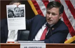  ?? CHIP SOMODEVILL­A — POOL VIA AP ?? Rep. Mike Johnson, R-La., holds up an article while questionin­g Attorney General William Barr during a House Judiciary Committee hearing on the oversight of the Department of Justice on Capitol Hill in July 2020in Washington. Johnson, the new leader of one of the houses of Congress that will certify the winner of next year's presidenti­al election, helped spearhead the attempt to overturn the last one.