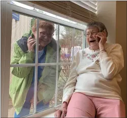  ?? COURTESY OF THE HIGHLANDS OF WYOMISSING ?? Diane Stevenson chats by phone with her mother, Elma Koskowski, a resident of the personal care unit of The Highlands of Wyomissing late in March 2020. Residents of senior living and care facilities quickly became isolated when the pandemic hit and their well-being quickly became a cause of concern.
