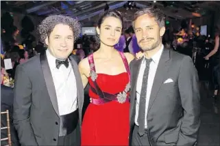  ?? Photograph­s by Mathew Imaging ?? MUSIC DIRECTOR GUSTAVO DUDAMEL, left, and actors Mia Maestro and Gael Garcia Bernal enjoy the Los Angeles Philharmon­ic’s opening-night gala. It raised $3.5 million.