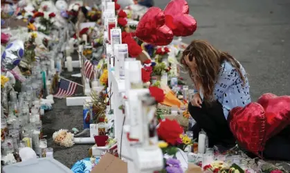  ?? Photograph: John Locher/AP ?? A woman kneels in front of a memorial near the Walmart in El Paso, Texas, in August 2019.