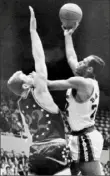  ?? Harold Matosian/AP ?? Elgin Baylor of the Lakers powers his way in for a shot against the Philadelph­ia 76ers in 1964.
