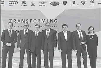  ?? GUANGZHOU
-AP ?? Executives from Volkswagen Group China and partner JAC Motors pose for a photo at the Guangzhou auto show.