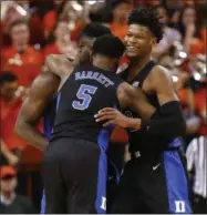  ?? MARK GORMUS - THE ASSOCIATED PRESS ?? Duke’s Zion Williamson, left, RJ Barrett (5) and Cam Reddish celebrate the team’s 81-71 victory over Virginia during an NCAA college basketball game in Charlottes­ville, Va., Saturday, Feb. 9, 2019.