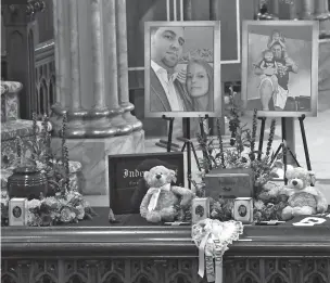  ?? PHOTOS BY HANS PENNINK/ASSOCIATED PRESS ?? A unity urn with the cremated ashes of Adam Jackson and Abigail Jackson is set in place as friends and family attend a funeral Mass on Saturday for eight of the 20 people killed in a limousine crash Oct. 6 in Schoharie, N.Y. The funeral Mass took place at St. Stanislaus Roman Catholic Church in Amsterdam, N.Y.