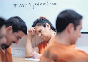 ?? ROBERTO E. ROSALES/JOURNAL ?? Bree, a Metropolit­an Detention Center inmate who is transgende­r, writes during a class exercise.