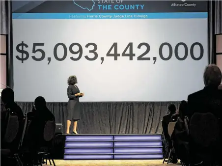  ?? Photos by Annie Mulligan / Contributo­r ?? Harris County Judge Lina Hidalgo stands in front of a budget number at her first State of the County address Friday in downtown Houston. Among other things, she lauded a historic settlement to reform Harris County’s bail system for misdemeano­r defendants.