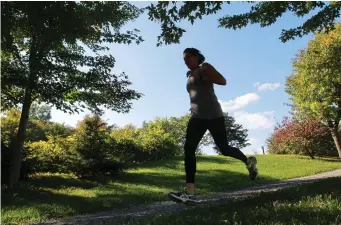  ?? JOHN KENNEY/THE GAZETTE ?? Fitness reporter Jill Barker jogging in Montreal on a path near Park Ave. Just 150 minutes of exercise a week from running and walking to yoga, Pilates, calistheni­cs and weight training will help you sleep.
