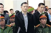  ??  ?? Vietnam’s lawyer Nguyen Van Dai, centre, and other political activists Pham Troi, left, and Naguyen Trung Ton, right, stand in a courtroom during their trial in Hanoi yesterday.