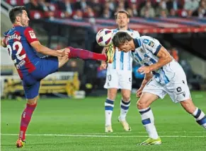  ?? — ap ?? trouble ahead: Barcelona’s Ilkay Gundogan almost lands his boot on Real sociedad’s Robin Le normand.