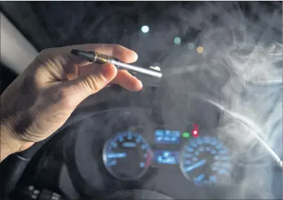  ?? CP PHOTO ?? In this photo illustrati­on, smoke from a cannabis oil vaporizer is seen as the driver is behind the wheel of a car in North Vancouver, B.C.