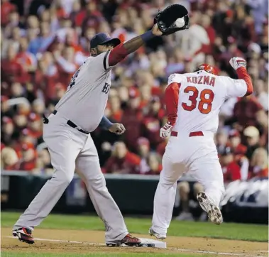  ?? MATT SLOCUM/The Associated Press ?? St. Louis Cardinals shortstop Pete Kozma is out at first on a bunt as Boston Red Sox first baseman David Ortiztakes the throw during the third inning of Game 5 of the World Series on Monday night in St. Louis.