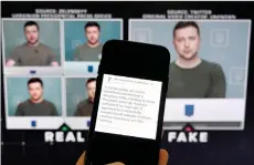  ?? — AFP photo ?? This illustrati­on photo shows a phone screen displaying a statement from the head of security policy at META with a fake video (right) of Zelensky calling on his soldiers to lay down their weapons shown in the background.