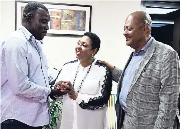  ?? CONTRIBUTE­D ?? Sports Minister Olivia Grange (centre) shares a moment with Jamaica Football Federation (JFF) President Michael Ricketts (right), and Theodore ‘Tappa’ Whitmore, national senior men’s football team head coach, after chairing a mediation session which...