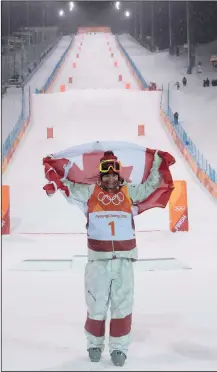  ?? THE CANADIAN PRESS/JONATHAN HAYWARD ?? Canadian Mikael Kingsbury celebrates his gold medal win following moguls finals at the Phoenix Snow Park at the Pyeongchan­g 2018 Winter Olympic Games in South Korea, Monday.