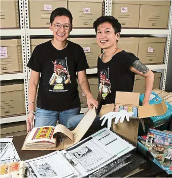  ??  ?? MDA members Ezrena (left) and Kee with some of the items in the archive. — YAP CHEE HONG/The Star