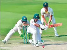  ?? AFP ?? Pakistan’s Fakhar Zaman plays a shot during his knock of 66 in the second innings of the second Test against Australia at the Abu Dhabi Cricket Stadium yesterday.