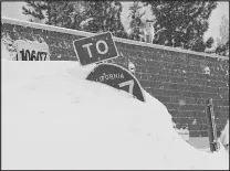  ?? BROOKE HESS-HOMEIER / ASSOCIATED PRESS ?? A highway sign is covered in snow Sunday in Truckee, Calif., northwest of Lake Tahoe.