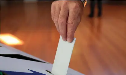  ?? Photograph: Rob Blakers/AAP ?? Under the Coalition’s voter integrity bill, Australian­s will have to show identifica­tion to cast their ballot on election day.