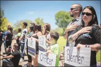  ?? ROBERTO E. ROSALES/JOURNAL ?? Rio Rancho residents hold their hands over their hearts while the hearse carrying Rio Rancho Police officer Gregg Benner makes its way along the procession route on June 4.