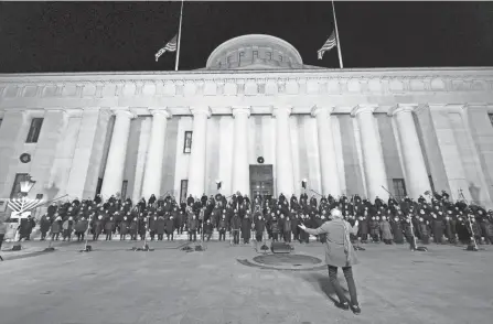  ?? NICOLAS GALINDO/COLUMBUS DISPATCH ?? Performers with the Harmony Project sing on the steps of the Statehouse in Columbus on Monday. The live performanc­e was the first one since December 2019 due to COVID-19 concerns last year.