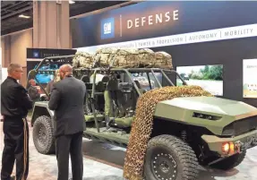  ?? GM DEFENSE ?? Vice Chief of Staff of the U.S. Army Joseph Martin, left, discusses the Infantry Squad Vehicle capabiliti­es with David Albritton, president of GM Defense at the 2019 Associatio­n of the U.S. Army conference in Washington, DC.