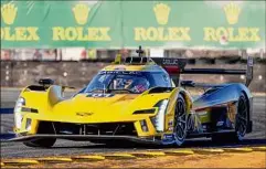  ?? John Raoux / Associated Press ?? The Cadillac Racing V-LMDH goes through a horseshoe turn during a practice session for the Rolex 24 hour auto race at Daytona Internatio­nal Speedway on Thursday.