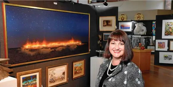  ?? Photos: Kevin Farmer ?? MASTERFUL WORK: Tiffany Jones of Tiffany Jones Fine Art Consultanc­y with the most expensive work on sale at the 2019 Downlands Art Exhibition - Night (Starlight Line) by Australian artist Tim Storrier.