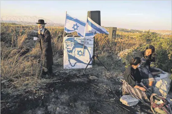  ?? Photo: Menahem Kahana/afp ?? Land grab: Israeli settlers gather on a hill next to the Palestinia­n town of Halhul in the occupied West Bank on Tuesday. The Israeli government plans to annex some parts of the West Bank, a move which Chief Justice Mogoeng Mogoeng (below) has failed to condemn.