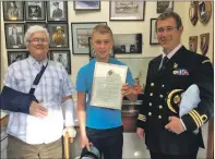  ?? t45hero1no ?? HONOURED: Andrew Paton, 13,
who saved his grandfathe­r Sandy Malcolm, 82, left, was
presented with a medal by Chief Coastguard Keith Oliver.