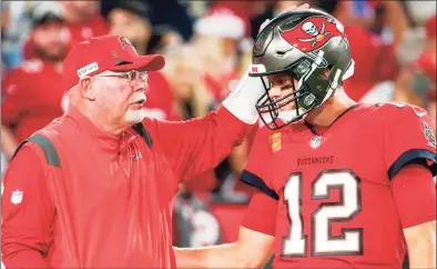  ?? Ivy Ceballo / TNS ?? Tampa Bay Buccaneers coach Bruce Arians and quarterbac­k Tom Brady talk prior to a game against the New Orleans Saints in December.