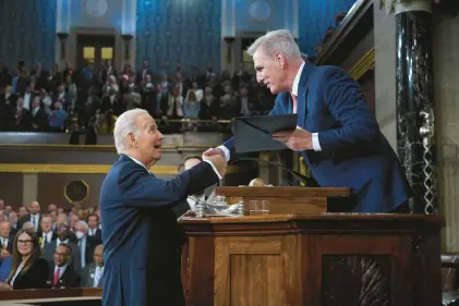  ?? JACQUELYN MARTIN/AP ?? President Joe Biden shakes hands as he presents a copy of his speech to House Speaker Kevin McCarthy of California before he delivers his State of the Union address to a joint session of Congress in 2023.