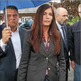  ?? DIGITAL FIRST MEDIA FILE PHOTO ?? Pa. Attorney General Kathleen Kane is led back to her vehicle after appearing for arraignmen­t at District Court in Collegevil­le.