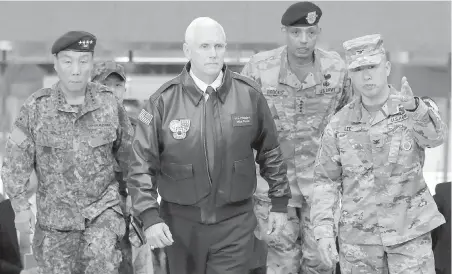  ??  ?? U.S. Vice-President Mike Pence, centre, arrives Monday with U.S. Gen. Vincent Brooks, second from right, commander of the United Nations Command, U.S. Forces Korea and Combined Forces Command, and South Korean Deputy Commander Gen. Leem Ho-young, left,...
