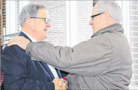  ?? KATHERINE HUNT/THE GUARDIAN ?? Ray Cantelo, right, congratula­tes Cardigan MP Lawrence MacAulay on his 30 years in federal politics during a celebratio­n at St. Peters Bay Complex Sunday. The now 72-year-old MacAulay was first elected as an MP on Nov. 21, 1988.