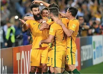  ?? Photo: BRENDAN ESPOSITO ?? BIG NIGHT: Australia’s Mile Jedinak (left), celebrates after scoring against Honduras. Willowburn Football Club will have Australia’s match against France live on the big screen tonight.