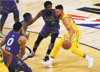  ??  ?? Stephen Curry of Team LeBron is defended by Kyrie Irving of Team Durant during the AllStar Game at State Farm Arena in Atlanta. Curry won the 3Point Contest before the game.