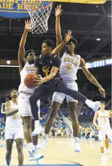  ?? Mark J. Terrill / Associated Press ?? Cody Riley (right) and Chris Smith helped the UCLA defense smother guard Paris Austin and the Cal offense.