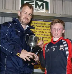  ??  ?? James Murray receiving the trophy from Johnny Murphy.