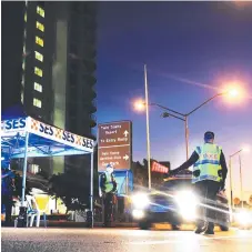  ?? Picture: SCOTT POWICK ?? Queensland Police stop vehicles in Coolangatt­a. Tweed Council has voted to urge NSW to adopt similar measures.