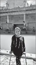  ?? ALEXANDRA PECCI/FOR THE WASHINGTON POST ?? Chloe at the Roman Baths in Bath, England. Although the uneven stones around the Great Bath were difficult for the transport chair to move across, Chloe had no trouble walking over them using her forearm crutches.