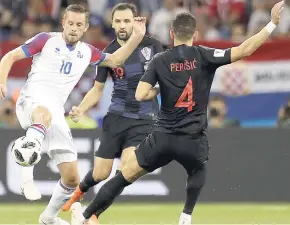  ?? AP ?? Iceland’s Gylfi Sigurdsson (left) and Croatia’s Milan Badelj and Ivan Perisic fight for the ball during the Group D at the 2018 World Cup in Russia.