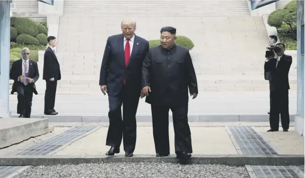  ??  ?? 0 US President Donald Trump and North Korean leader Kim Jong Un inside the demilitari­sed zone separating South and North Korea yesterday