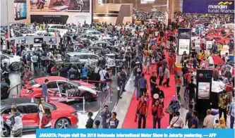  ??  ?? JAKARTA: People visit the 2018 Indonesia Internatio­nal Motor Show in Jakarta yesterday. — AFP