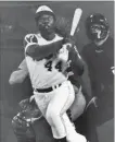  ??  ?? Atlanta Braves’ Hank Aaron, seen here eyeing the flight of his 715th homer, breaking Babe Ruth’s all-time home-run record, on April 8, 1974, became a first-ballot Hall of Fame inductee,
36 years ago today.