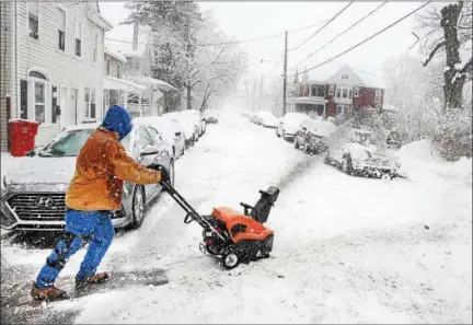  ?? TOM KELLY III — FOR DIGITAL FIRST MEDIA ?? Glen Knapper fights an uphill battle to clear snow at his home on North Franklin Street in Pottstown on Wednesday afternoon.