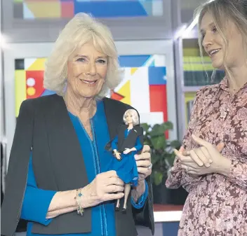  ?? ?? MINI-ME: Queen Camilla, president of Women of the World, is presented with a Barbie doll, dressed in her outfit, in recognitio­n of her work supporting the charity during a reception to celebrate Internatio­nal Women’s Day.