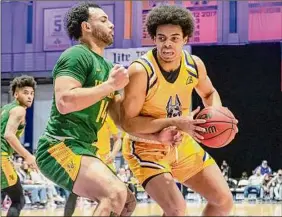  ?? James Franco / Special to the Times Union ?? UAlbany freshman Justin Neely drives to the basket in front of Vermont senior Isaiah Powell, a Colonie graduate. Neely finished with 26 points.