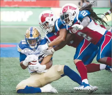  ?? The Canadian Press ?? Winnipeg Blue Bombers’ Andrew Harris, left, goes in for a touchdown during first-half CFL action against the Montreal Alouettes in Montreal on Friday night. Winnipeg won 56-10.